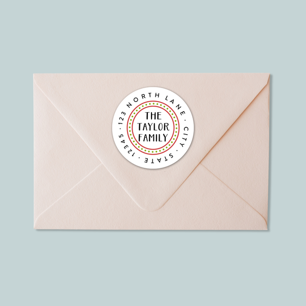 A light pink envelope with a white circular label on the top right corner displaying the text "THE TAYLOR FAMILY CITY STATE ST. LOUIS".