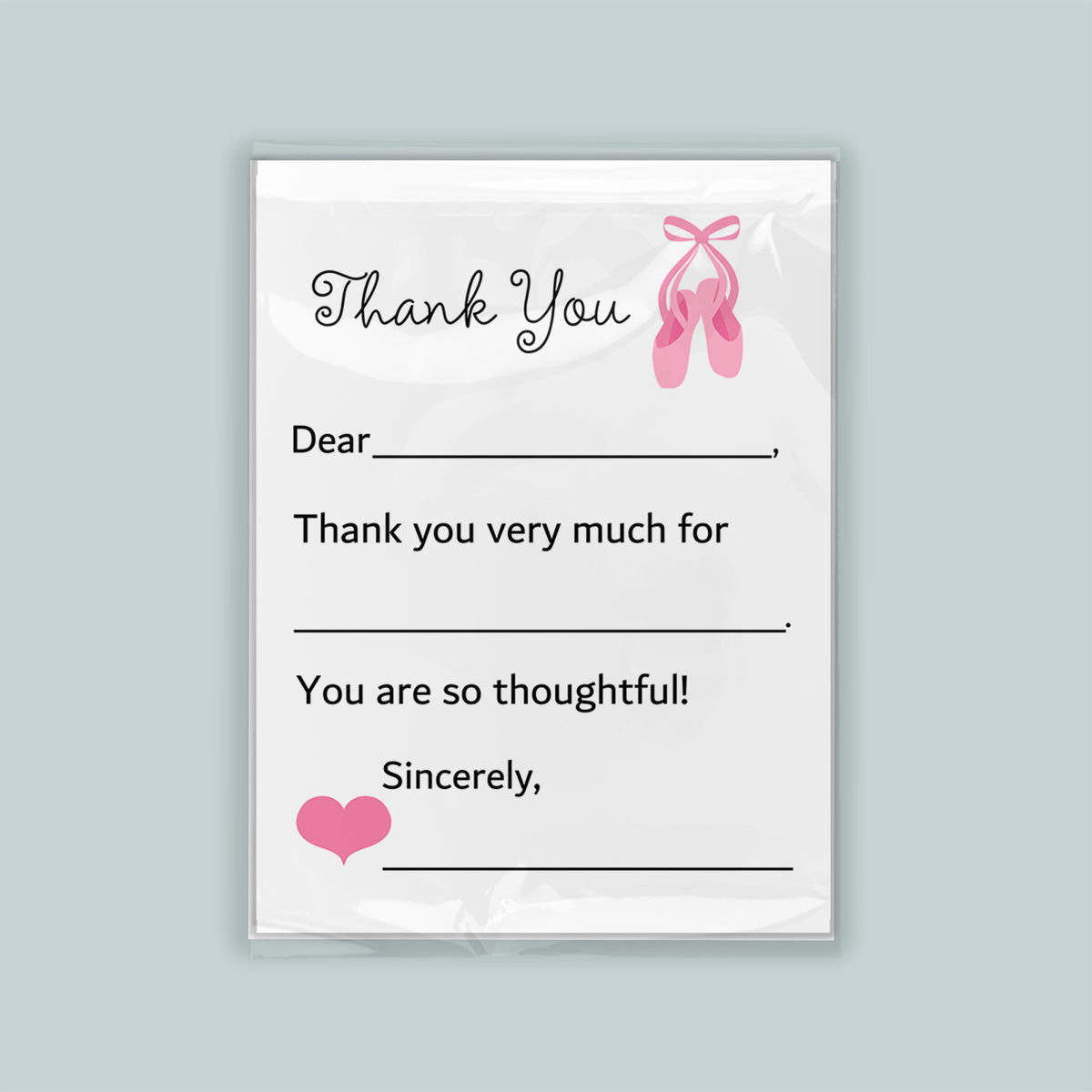 The image is a white thank you card with a pink ballet shoe graphic and a heart symbol. The card has a blank space for a recipient's name and a message expressing gratitude.