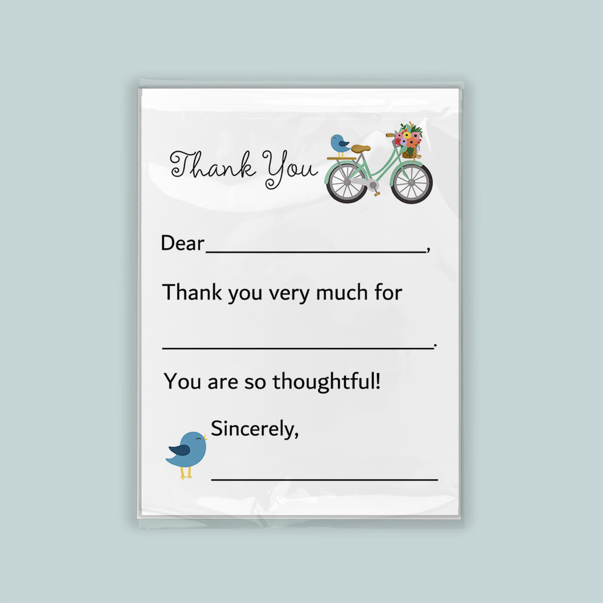 The image is a white card with a bicycle and a bird on it. The card has a message written on it, expressing gratitude.