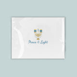 A white rectangular card with a stylized design of a menorah and the text 