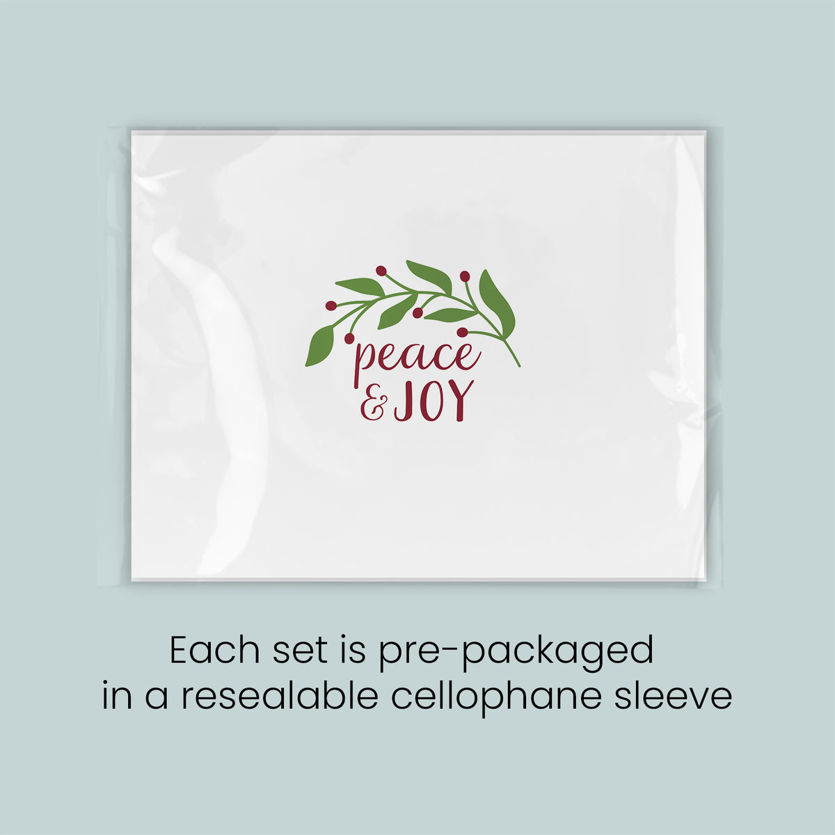 A white rectangular card with a red and green design featuring the text "Peace & Joy" and a wreath of leaves and berries.