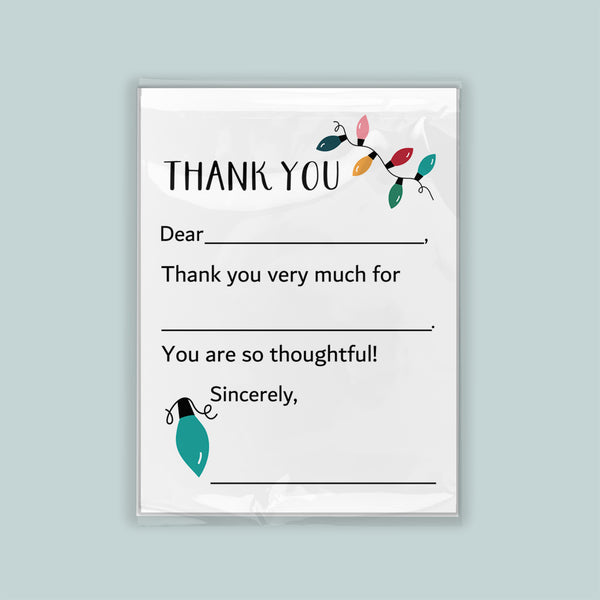 The image is a white thank you card with a green light bulb and colorful lights on the left side. The card has a blank space for a recipient's name and a message expressing gratitude.