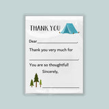 The image is a white card with a blue tent and pine trees on it. The card has a message that says 