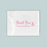 The image is a white card with a pink ribbon symbol and the text 