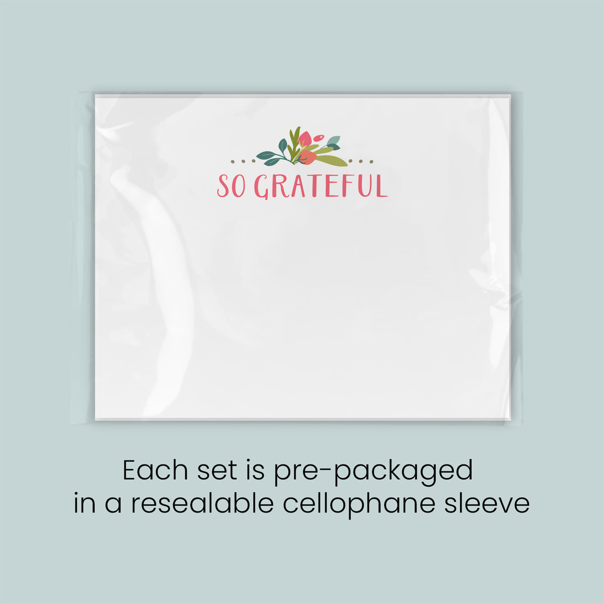 A white rectangular card with the text "SO GRATEFUL" printed on it, along with a decorative floral design. The card is pre-packaged in a resealable cellophane sleeve.
