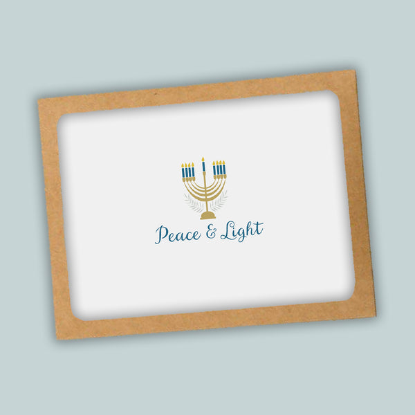 A greeting card with a peace and light theme, featuring a stylized menorah with candles and the text "Peace & Light" on a white background.