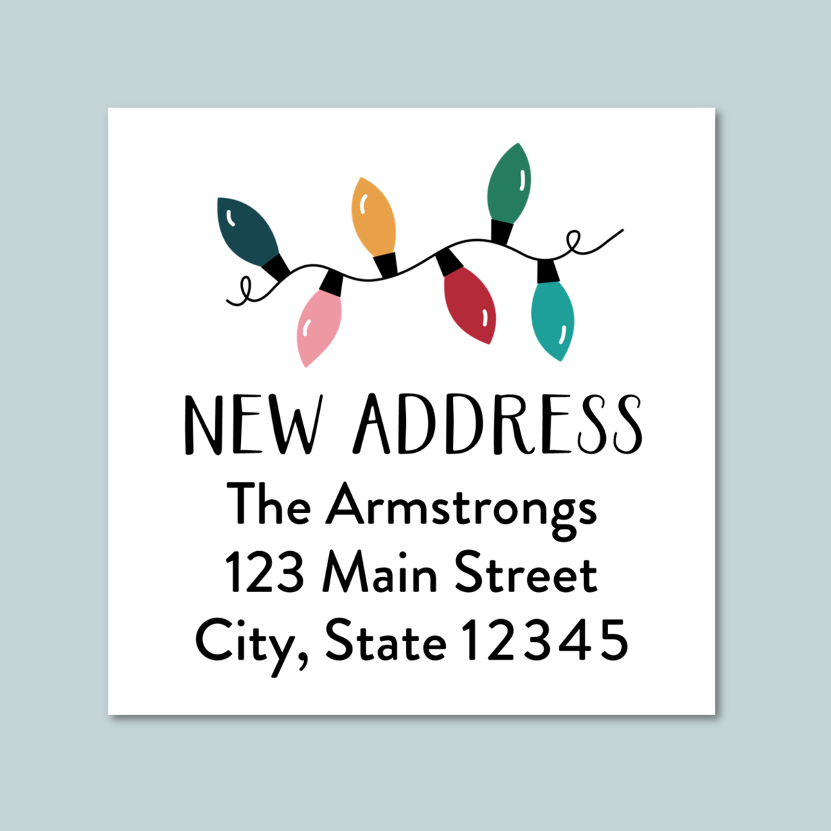 a white address label with a festive design featuring colorful Christmas lights.