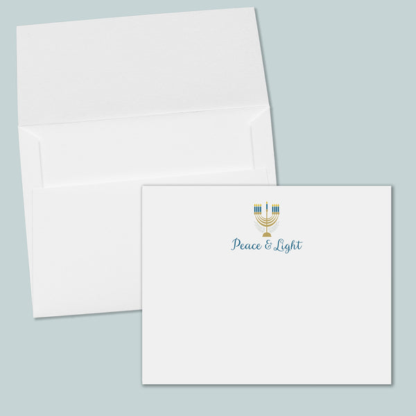 an open white envelope with a printed "Peace & Light" logo on the front.