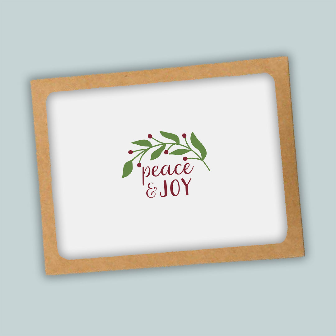 A white background with a brown frame containing a decorative wreath and the text "Peace & Joy" in a cursive font.