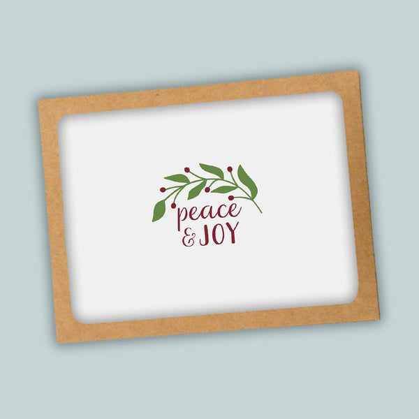 A white background with a brown frame containing a decorative wreath and the text "Peace & Joy" in a cursive font.
