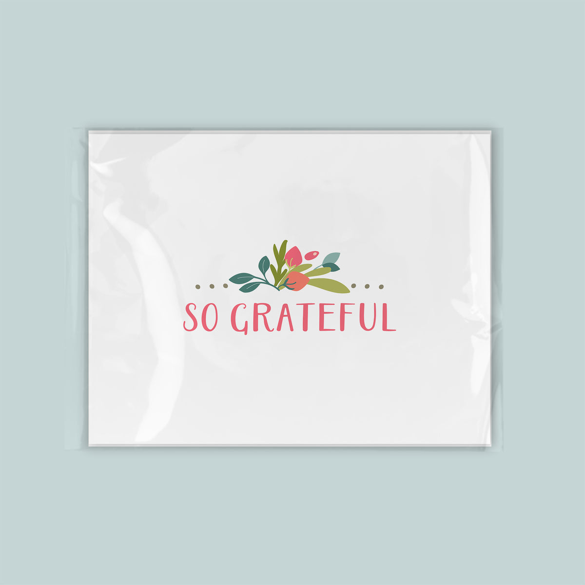 A white square with a floral design and the text "So Grateful" written in pink and green.