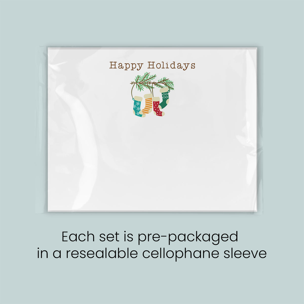A white greeting card with a festive holiday design, including a stocking and a pine branch. The card is pre-packaged in a reesealable cellophane sleeve.