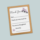 The image is a brown card with a white background, featuring a pair of purple skates and a snowflake design. The card has a message that reads 