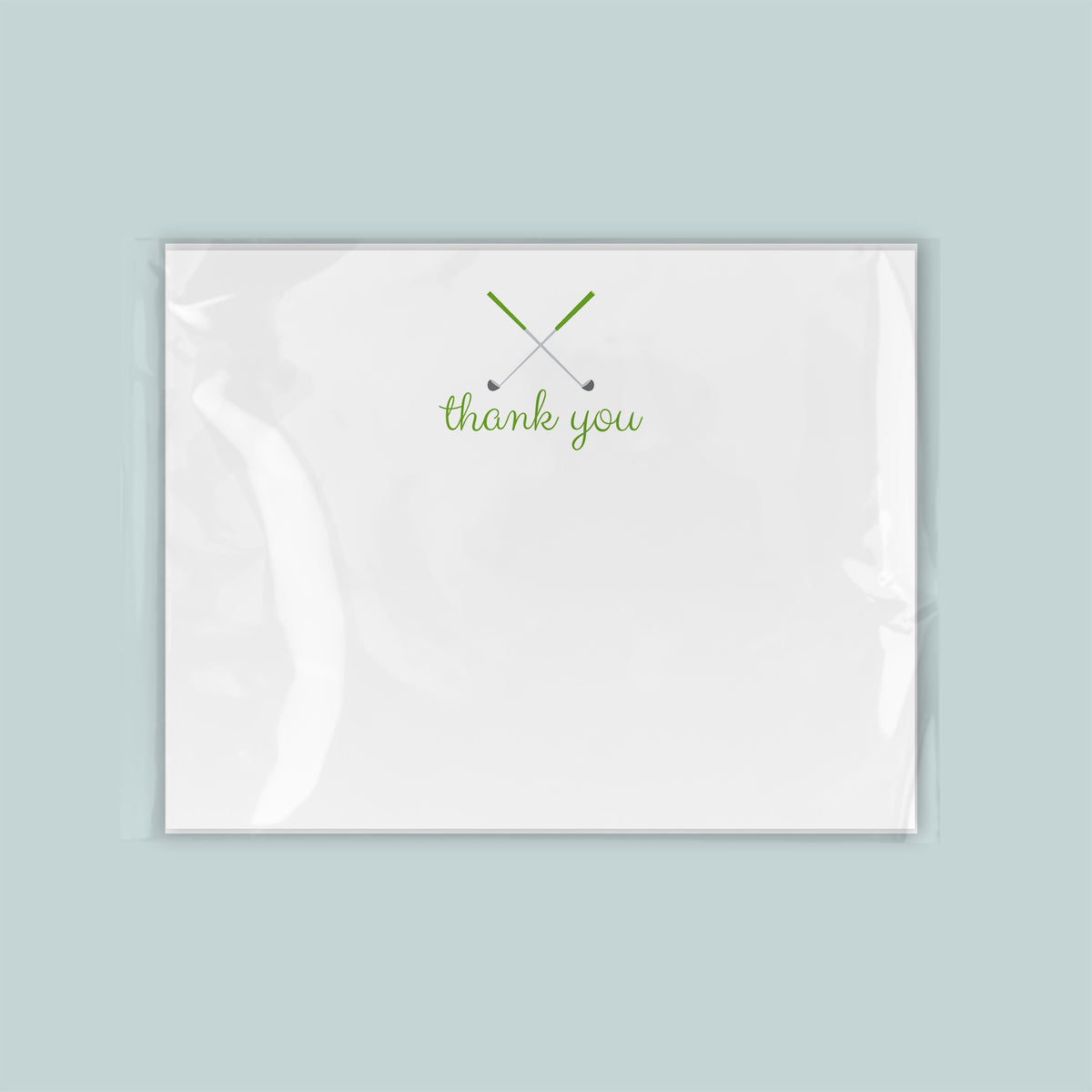 A white card with a green "thank you" message printed on it.