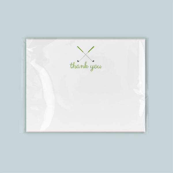 A white card with a green "thank you" message printed on it.