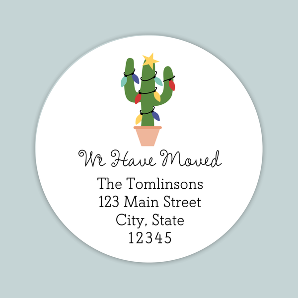 A white circular label with a cactus illustration and text that reads "We Have Moved The Tomlinson's 123 Main Street City, State 12345".