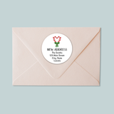 A light pink envelope with a white circular label that reads 