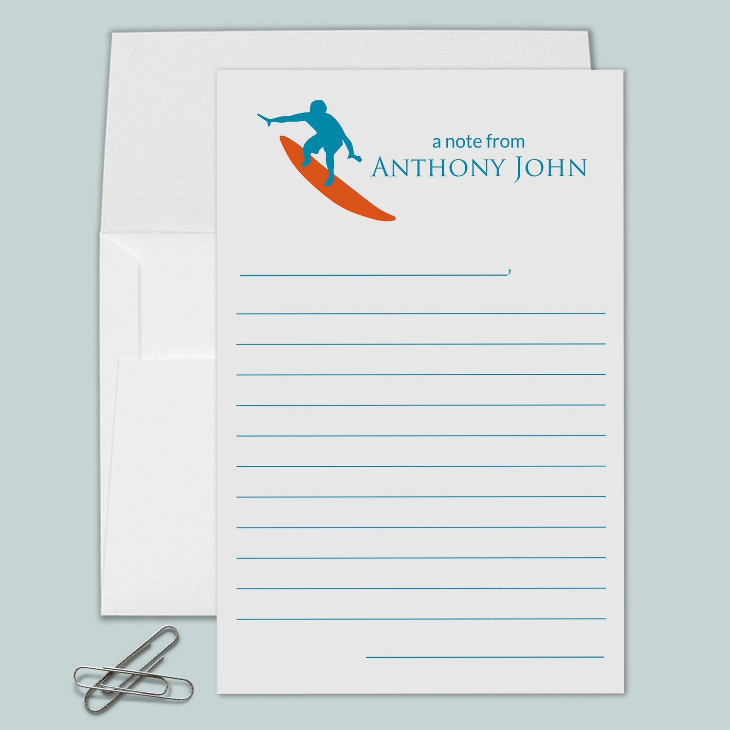 blue and orange surfer on top of personalized lined stationery with envelope