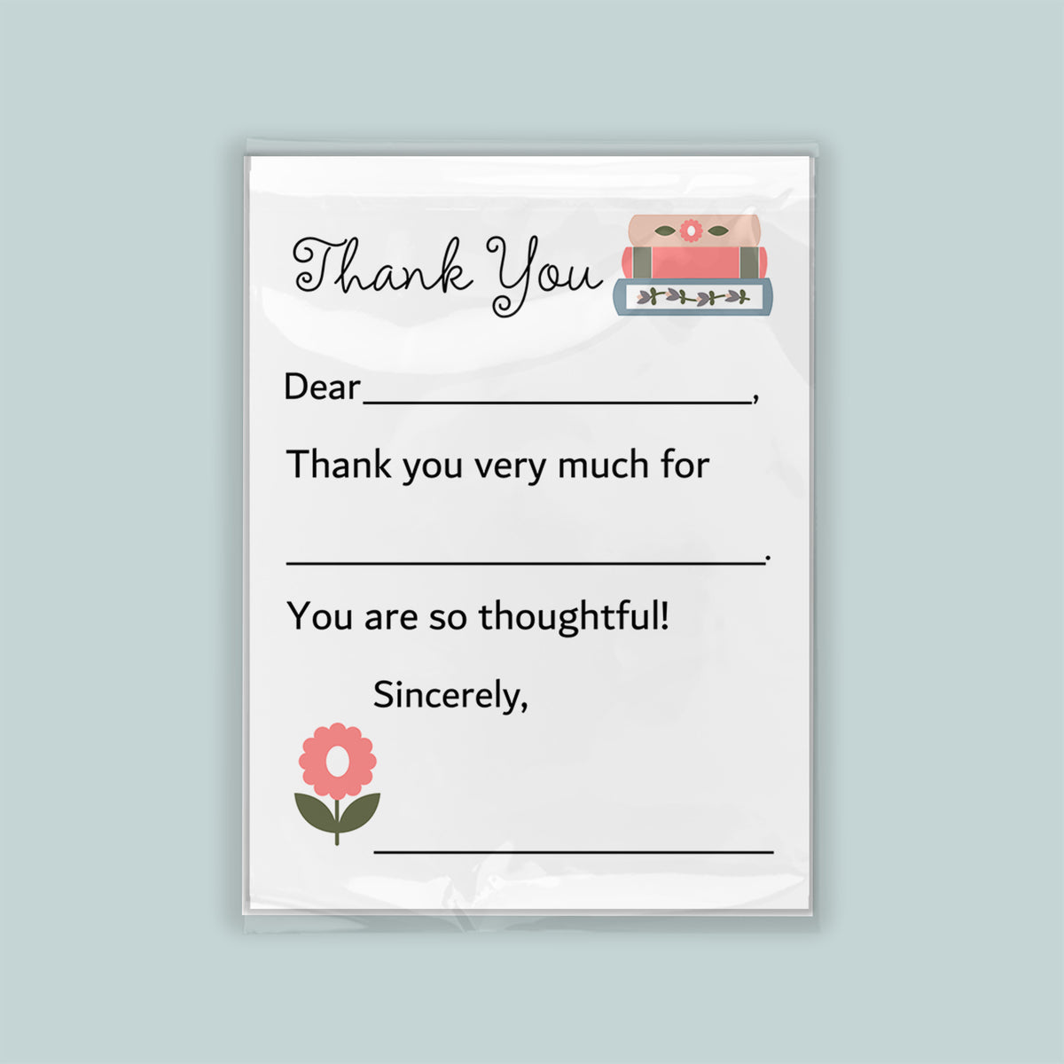 The image is a white thank you card with a pink flower and a stack of books as decorations. The card has a blank space for a message and a blank space for a signature.