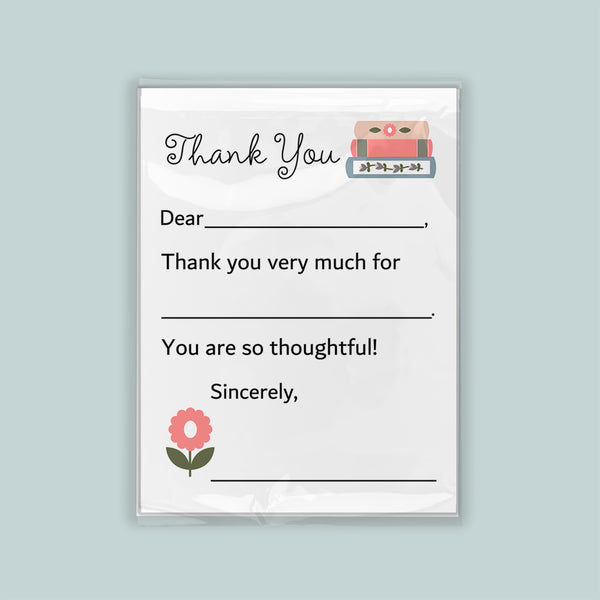 The image is a white thank you card with a pink flower and a stack of books as decorations. The card has a blank space for a message and a blank space for a signature.