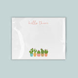 A white background with a line of colorful cacti in pots, accompanied by the text 