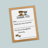 The image is a brown card with a white background, featuring a cartoon image of a dog and a cat. The card has a message that reads 