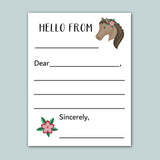 The image is a blank greeting card with a horse illustration and a pink flower. The card has a blank space for a message and a blank space for a signature.