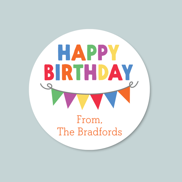 A round sticker with the text "HAPPY BIRTHDAY" in colorful letters, along with a row of colorful triangular flags below it.
