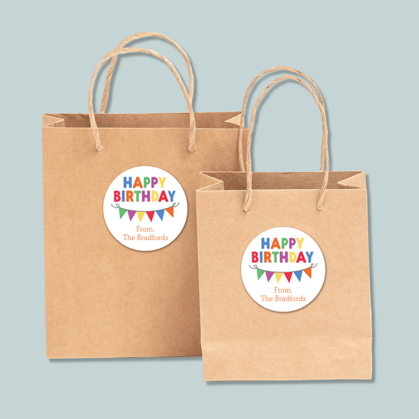 Two brown paper shopping bags with a "Happy Birthday" sticker on them.
