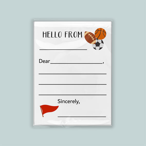 The image is a white envelope with a sports theme, featuring a basketball, soccer ball, and a flag. The envelope has a blank space for a message and a blank space for a name. The message is "Hello from" and the name is "Sincerely," but the rest of the text is not visible in the image.