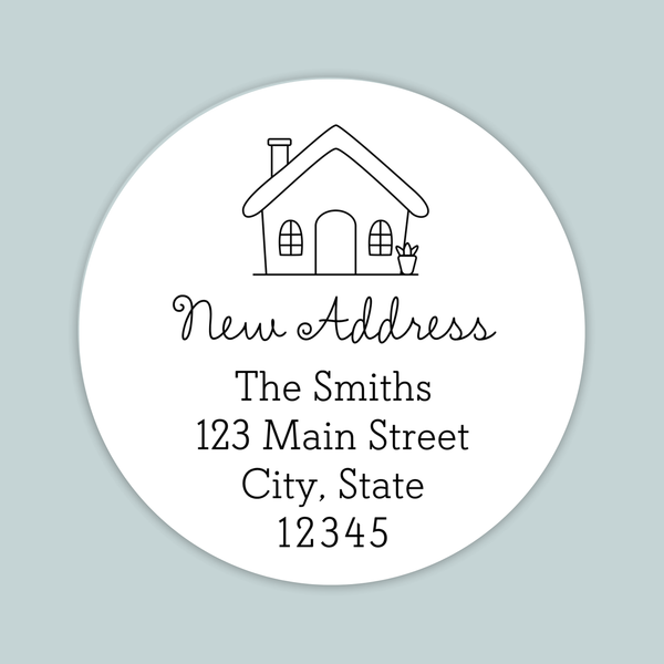 A white circular address label with a house illustration and text providing the address of The Smiths at 123 Main Street, City, State 12345.