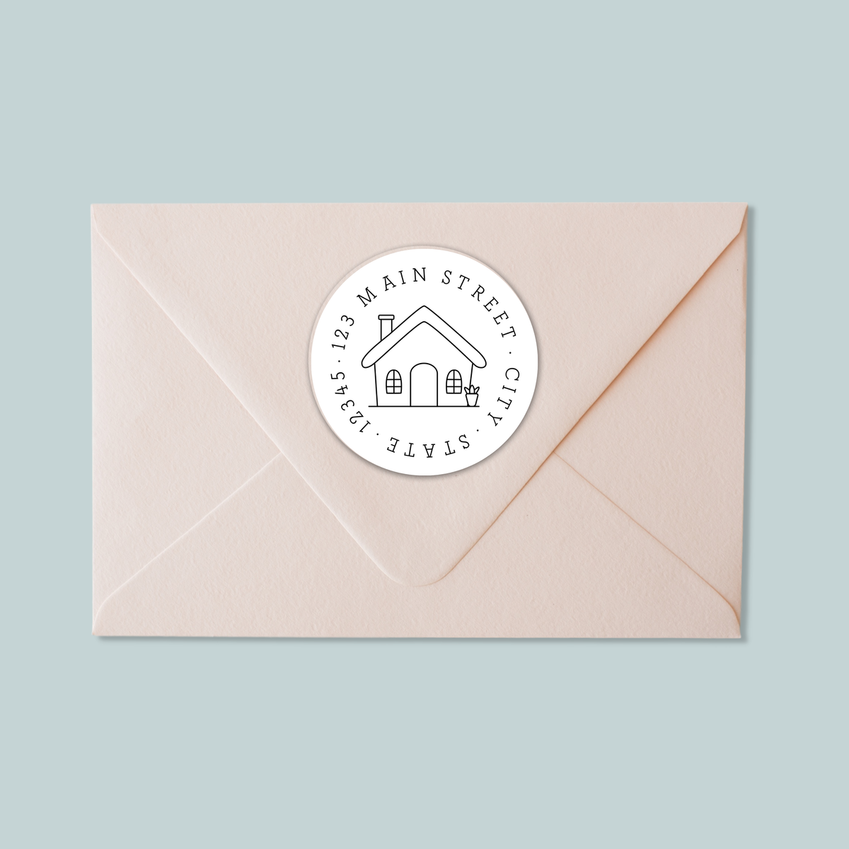 A light pink envelope with a white circular stamp featuring a house illustration and text.