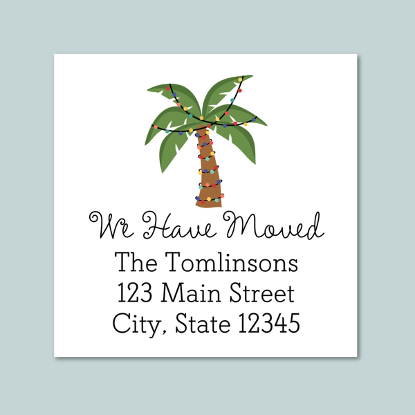 The image is a white envelope with a tropical palm tree illustration and text that reads "We Have Moved The Tomlinson's 123 Main Street City, State 12345".