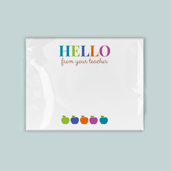A greeting card with the text "Hello from your teacher" and four colorful apple illustrations below it.