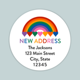 The image is a white circular label with a rainbow graphic and the text 